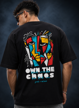 Man wearing the black Half Skull Abstract Soul oversized T-shirt with the cubist face and Own The Chaos back print