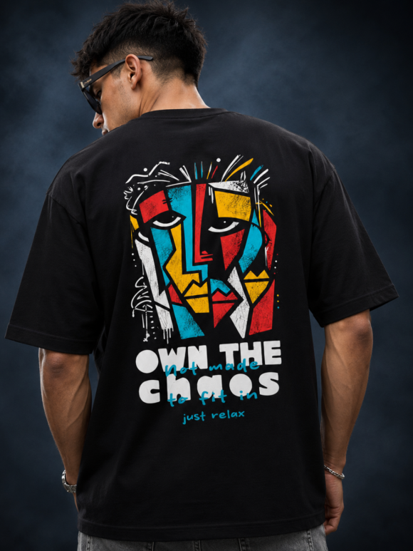 Man wearing the black Half Skull Abstract Soul oversized T-shirt with the cubist face and Own The Chaos back print