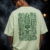 Back of the mint green Aztec Skull oversized T-shirt showing the green Mesoamerican glyph panel around a sugar skull