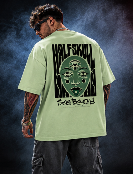 Back view of the pastel green Beyond Vision oversized T-shirt showing the liquid Halfskull wordmark and See Beyond script