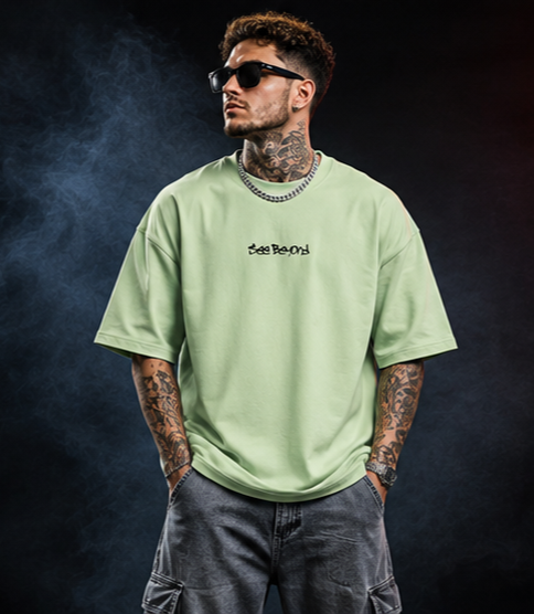 Model standing in the pastel green Beyond Vision oversized T-shirt showing the relaxed oversized fit