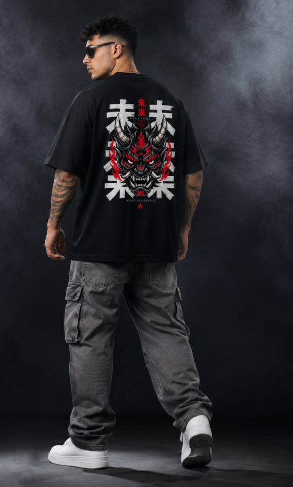 Full length back view of a model in the black Inferno Oni oversized T-shirt with grey cargo trousers